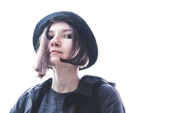 Low Angle Portrait Of Young Woman Against White Background