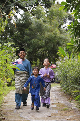 Girl running while boys are holding flags