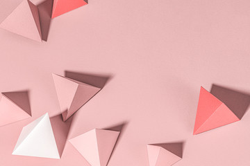 3D pink pyramid paper craft on a pink background