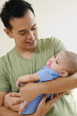 Man carrying baby
