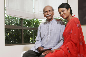 Woman posing with her father, smiling