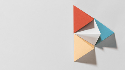 3D colorful pyramid paper craft on a gray background