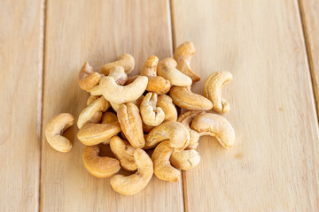 Many Roasted salted cashew nuts  on wooden background