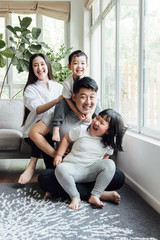Asian family playing in the living room