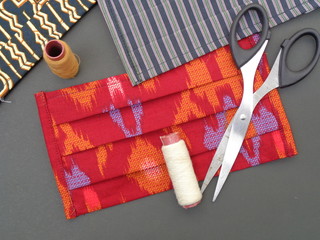 Fototapeta premium Fabric face mask with batik (ethnic) motif and pattern from Indonesia is very stylish and it can protect from air polution. Stylish Handmade masker to protect from corona virus or Covid 19.