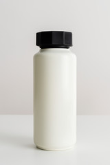 Minimal white water bottle with a black lid