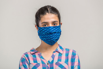 Portrait of a  girl covered with  homemade mask for prevention during covid-19 pandemic in India