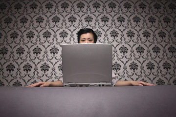 Woman sitting behind laptop