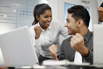 Businesspeople smiling and showing fist