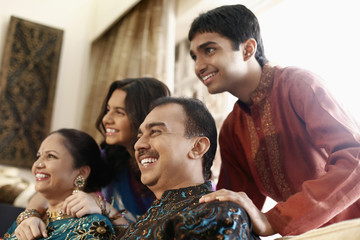 Young man and teenage girl posing with their parents