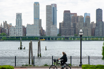 A New Jersey cyclist rides past the New York City Skyline while in quarantine