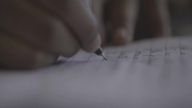 student writing with pen on paper close up India