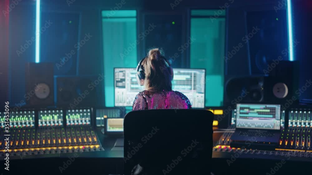 Aufkleber artist, musician, audio engineer, producer in music record studio, uses control desk with computer s