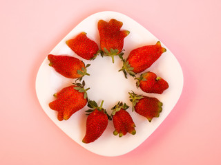 Ugly food: unusual strawberries in a plate