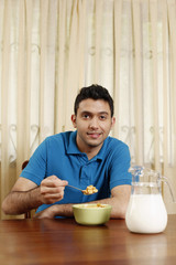 Fototapeta na wymiar Man enjoying a bowl of breakfast cereal