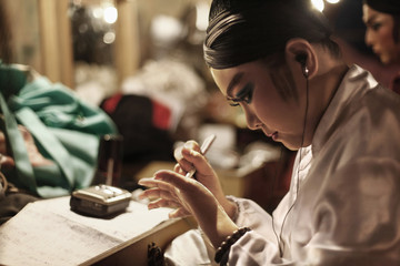 Opera performer writing script on her palm