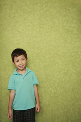 Boy standing at the wall looking away