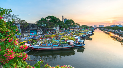Flower boats full of flowers parked along canal wharf in sunset, a place for bustling flower market...