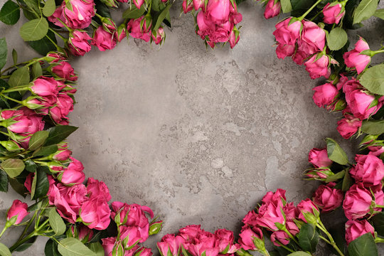 Flatlay spray pink rose free center space on light gray textured background. Flat lay, top view, copy space. Spring, fresh, nature. floristic shop eco concept Woman's Day Mother's St. Valentine's Day