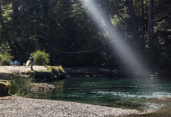 man fishing on the river  in patagonia
