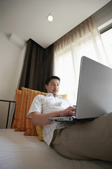 Man using laptop in the hotel room