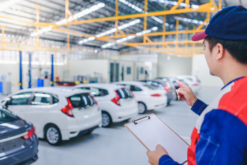 Employees are counting the number of new cars in stock to prepare to sell new cars. Car dealer