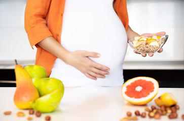Obraz na płótnie Canvas Pregnant woman cooking meal.