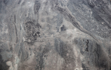 Black marble, polished surface of natural stone with a wavy white pattern.