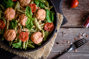 Delicious fresh pasta with meatballs, sauce, cherry tomatoes and basil