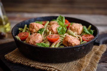 Delicious fresh pasta with meatballs, sauce, cherry tomatoes and basil
