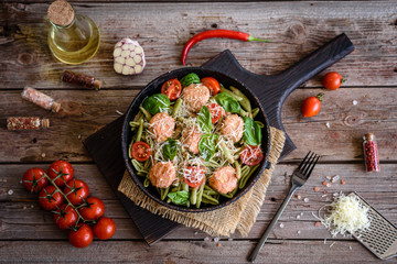 Delicious fresh pasta with meatballs, sauce, cherry tomatoes and basil