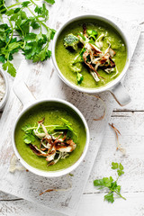 Homemade broccoli soup with horseradish and parsley chips