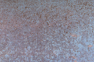 The blue iron surface is covered with rust. Background