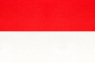 Republic of Indonesia national fabric flag, textile background. Symbol of international world asian country.
