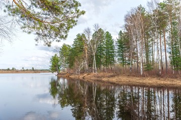 Spring landscape on the spilled river