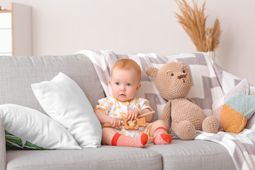 Cute little baby with toys at home