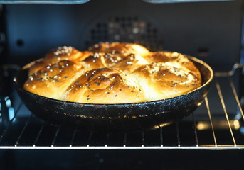 Homemade pies in round pan in the oven baked.Buns from yeast dough.