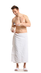 Obraz premium Handsome man with shower gel and loofah on white background