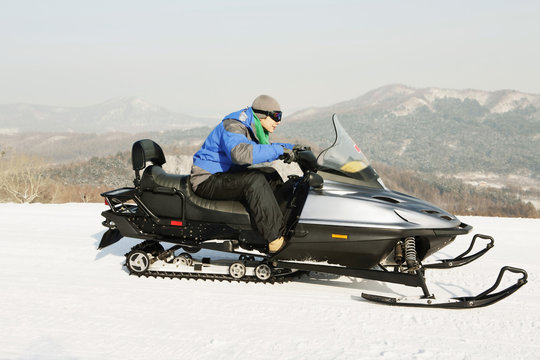 Man Riding On Snowmobile