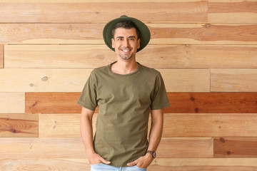 Man in stylish t-shirt on wooden background
