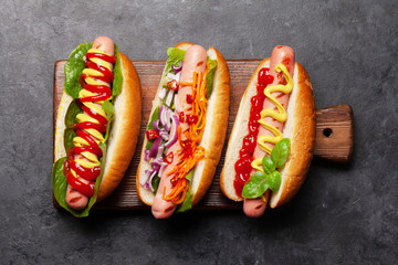 Various hot dog with vegetables, lettuce and condiments