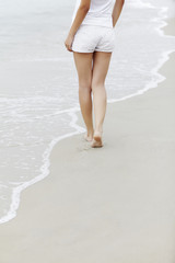 Woman walking along the beach