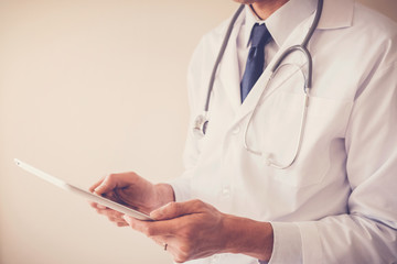 Medical doctor hands holding tablet, using app working remotely, telehealth, online health technology concept