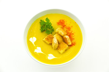 lentil soup puree with cream and dill in a bowl on a white background, crackers and paprika for decoration in food, a traditional Russian dish
