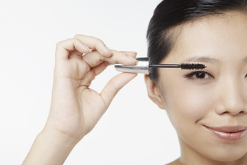 Fototapeta premium Woman applying mascara