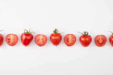 Top above overhead view photo of a row of cherry tomatoes isolated on white background