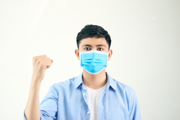 A white shirt Thai man is wearing a blue mask in lighting set up studio