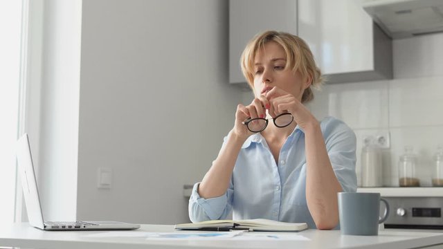 Bored woman suffering from lack of inspiration working at home, freelance
