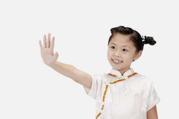 Girl in cheongsam smiling and holding out her hand