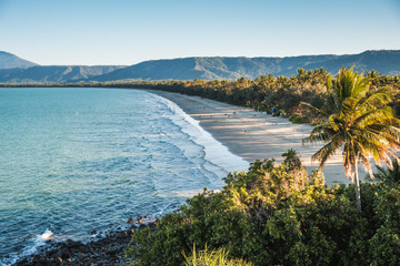 Aerial view on beach surrounded by mountains and trees in Australia